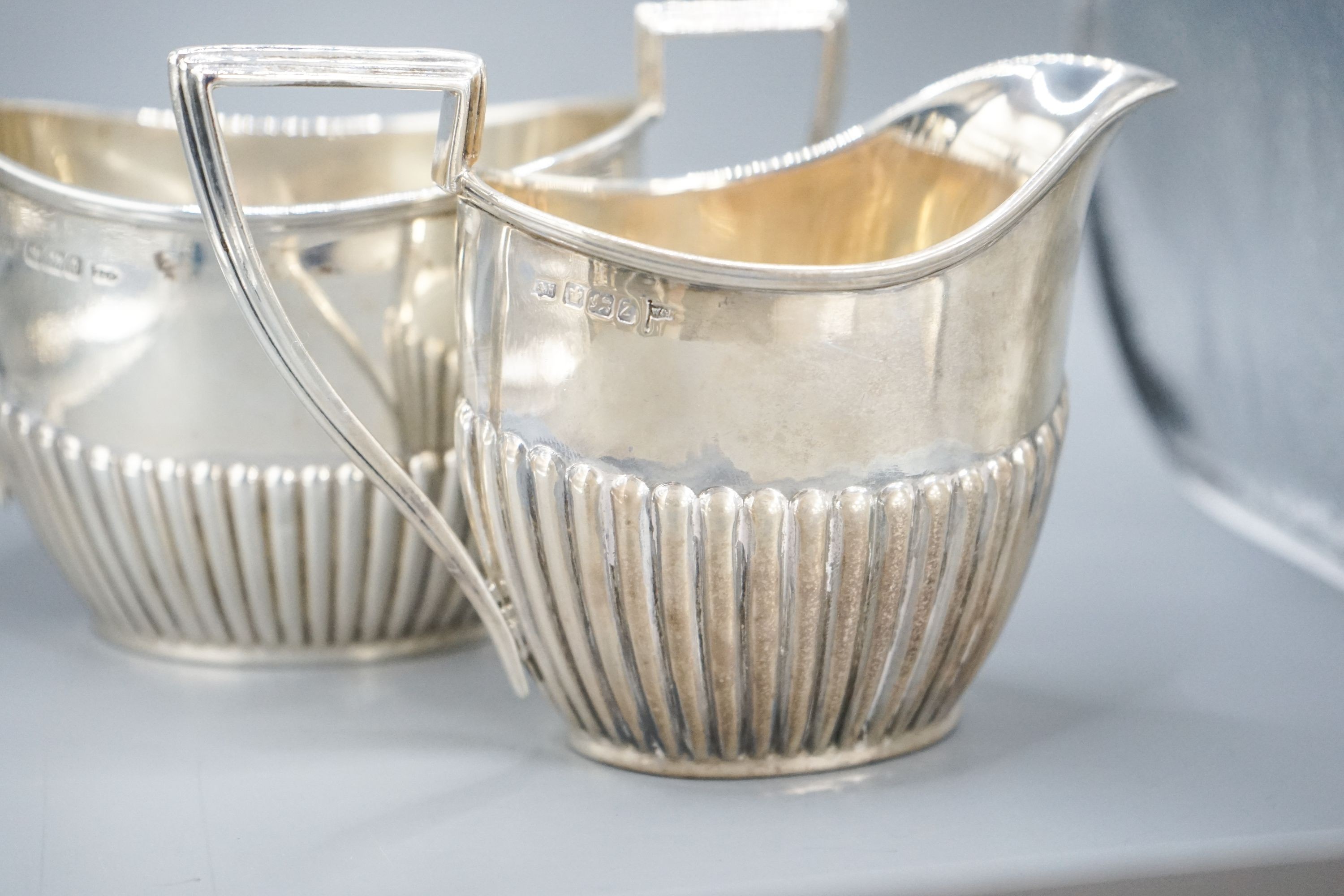 A late Victorian fluted silver cream jug and matching sugar bowl, by Walker & Hall, Sheffield, 1892/3, 13oz.